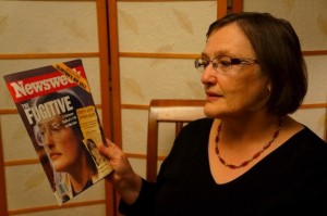 Katherine Power holding the Newsweek cover story of her experiences.
